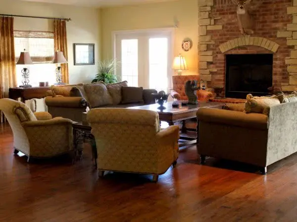 Living room with plush seating and a brick fireplace