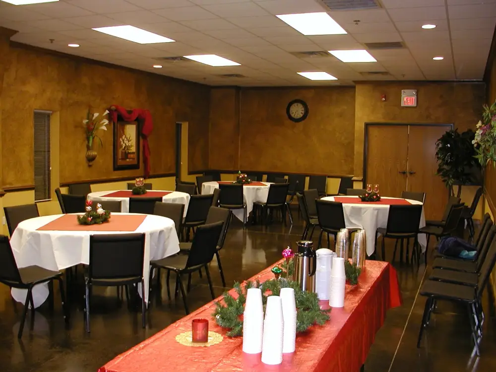 Reception room with round tables and a beverage station